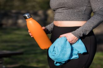 Picture of woman in exercise attire with focus on the stomach.